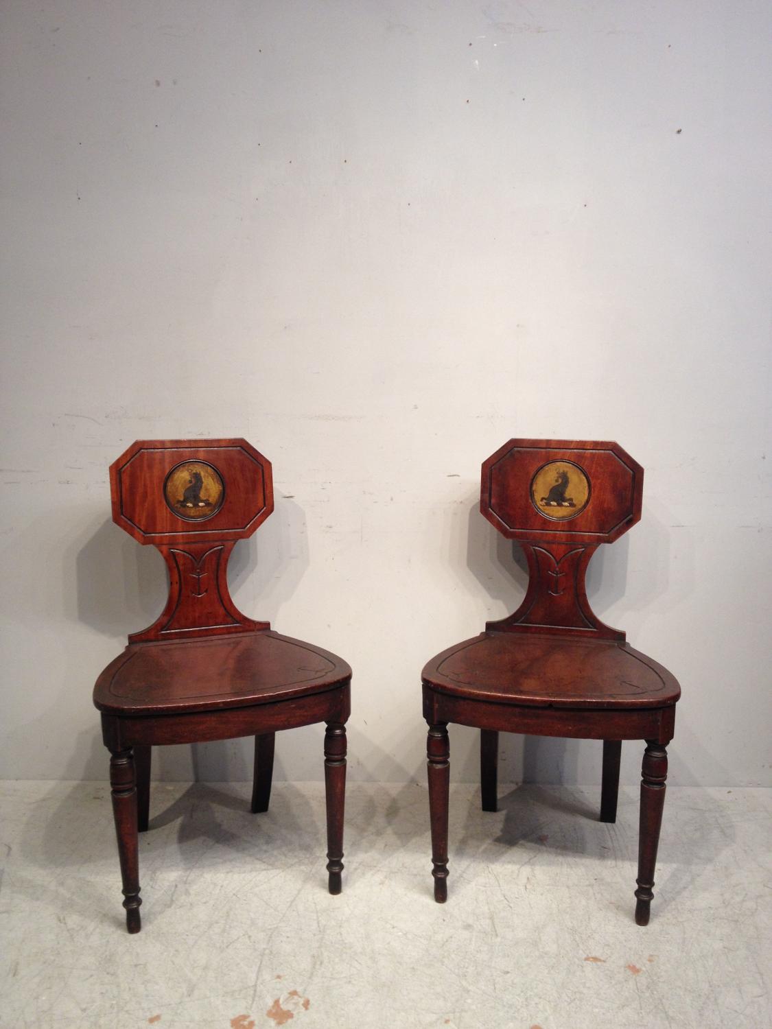 Pair of Georgian mahogany hall chairs.