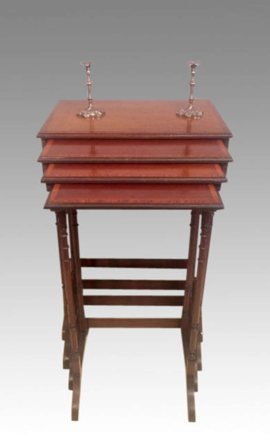 An nest of four antique mahogany tables.