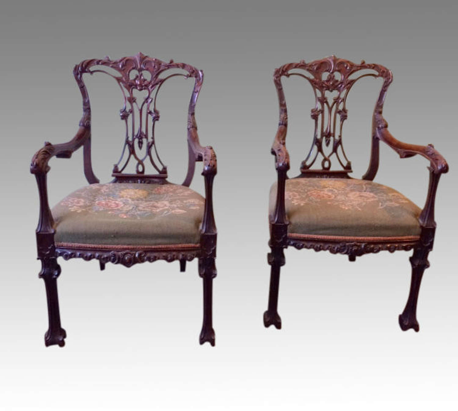 A pair of  carved Chippendale Revival mahogany armchairs.