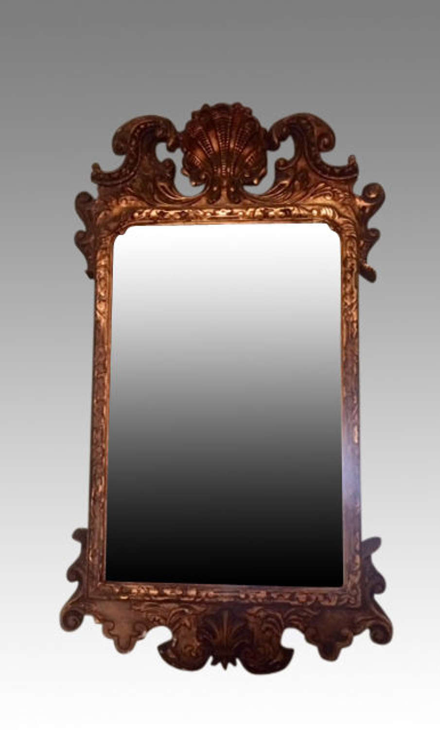 A Geo II style antique carved giltwood mirror.