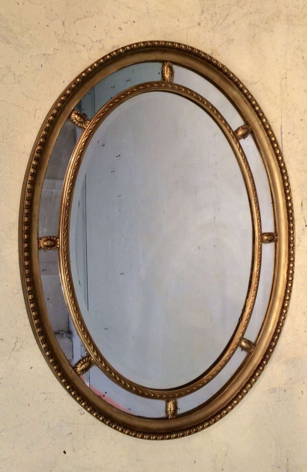 19th century oval carved giltwood mirror.