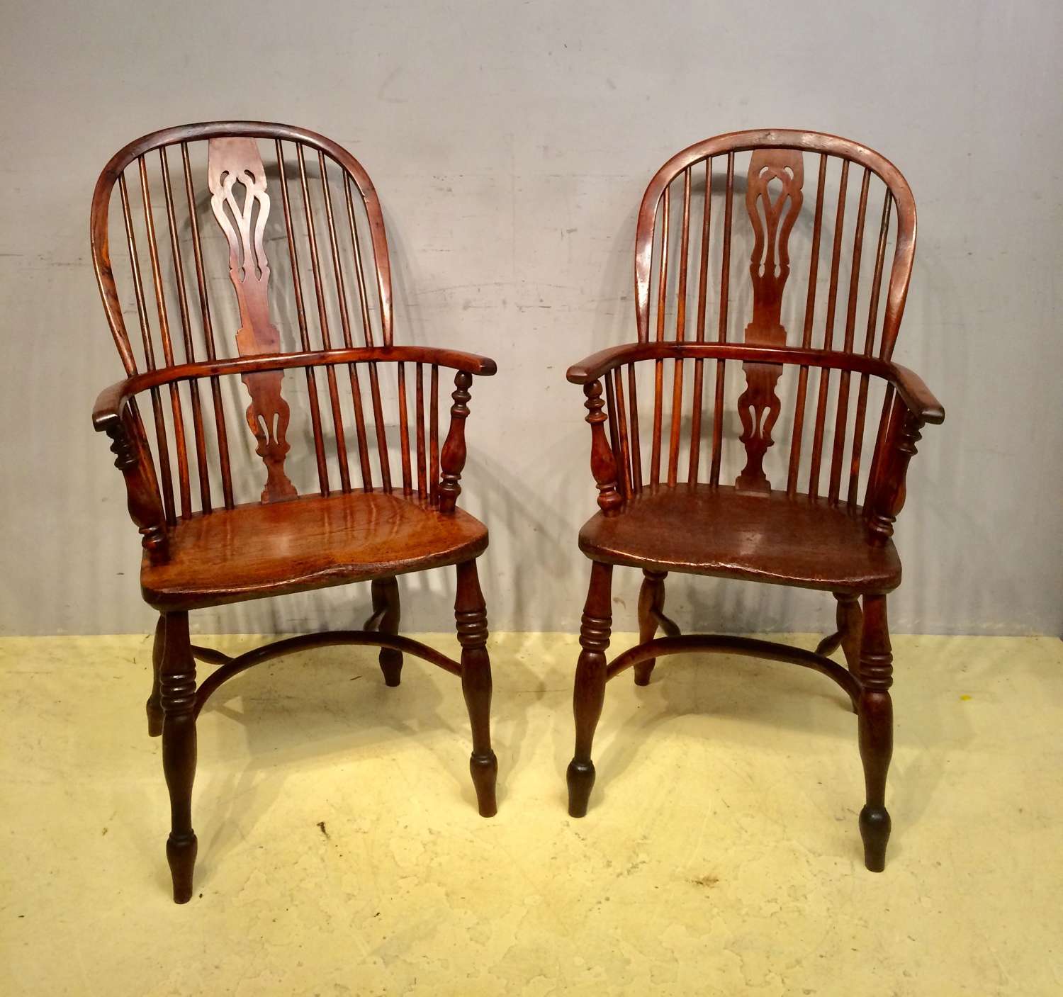 A matched pair of 19th century yew wood Windsor armchairs