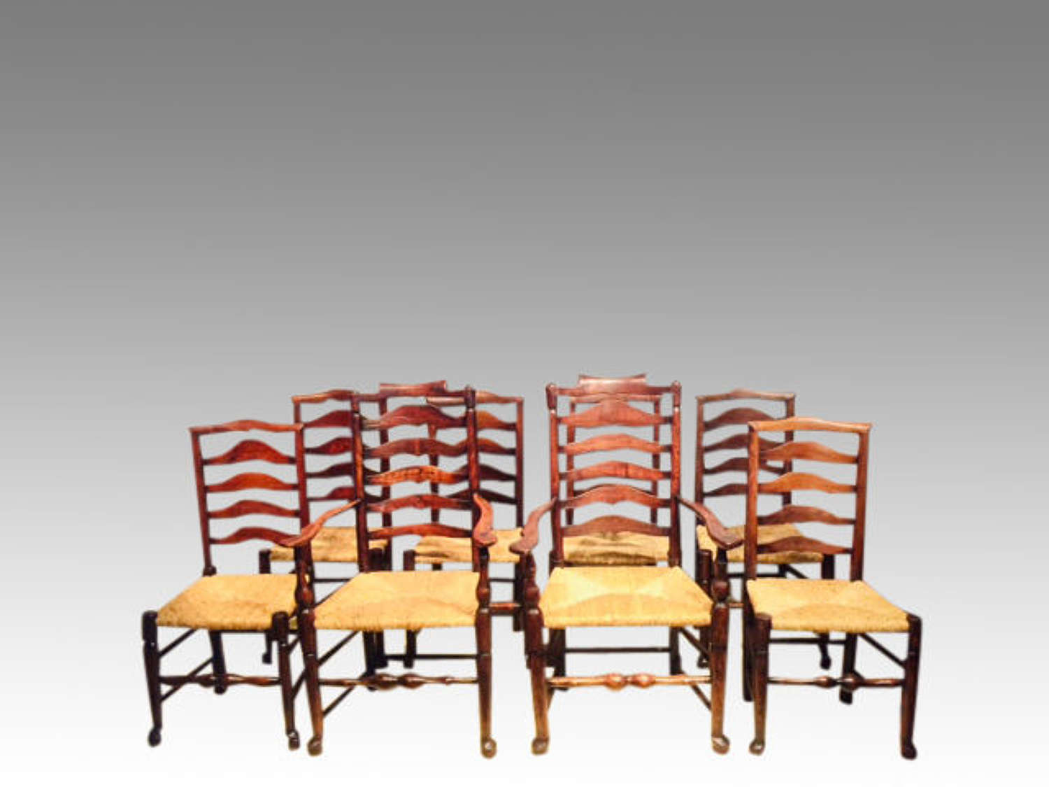 Set of 8 antique Lancashire rush seat dining chairs.