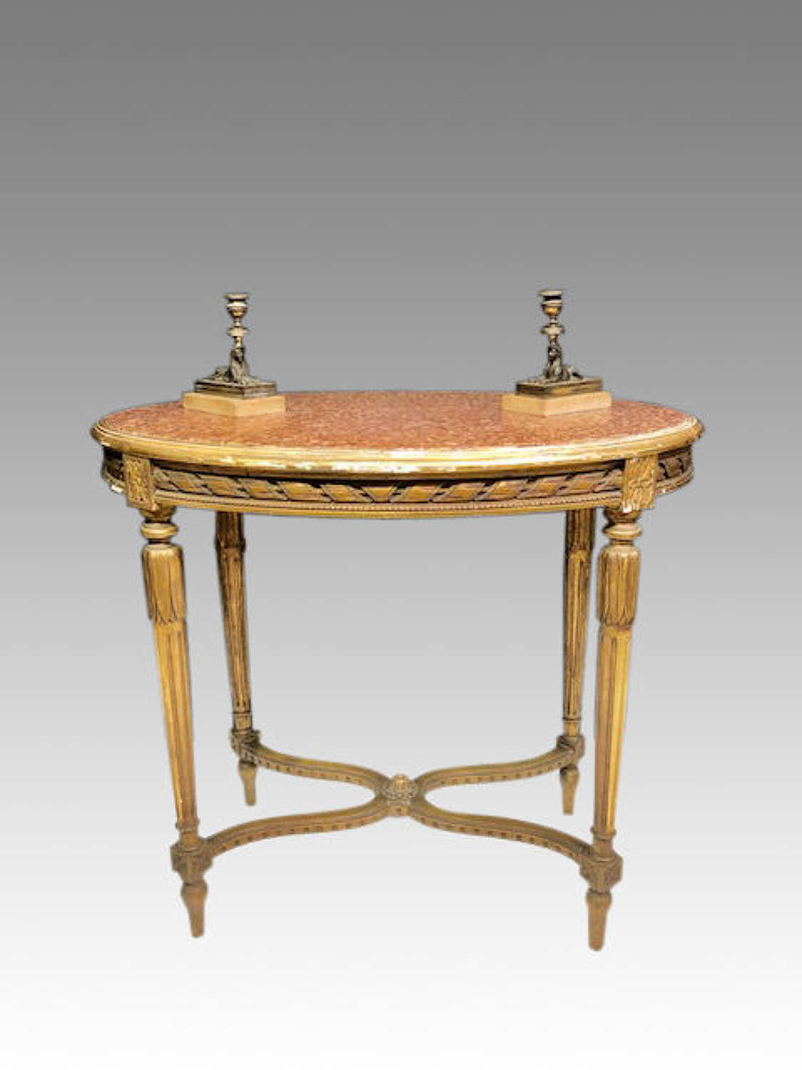 19th century oval marble topped carved giltwood table .