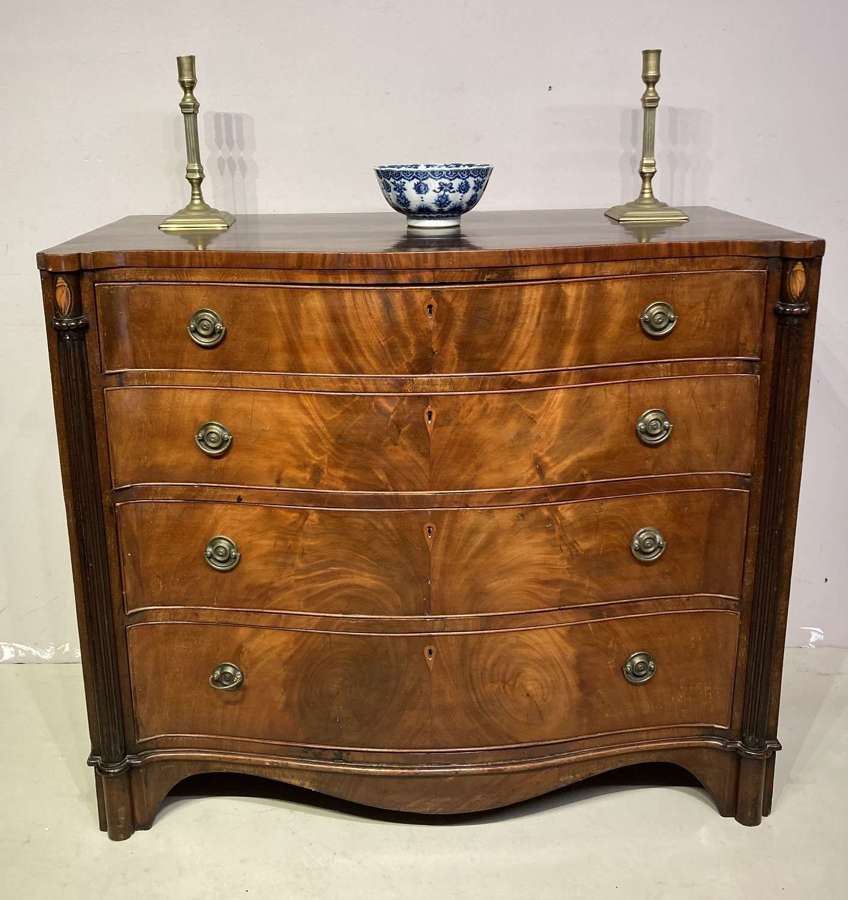 Antique serpentine mahogany chest of drawers.
