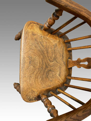 Early 19th century yew and ash child's Windsor armchair.