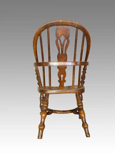 Early 19th century yew and ash child's Windsor armchair.
