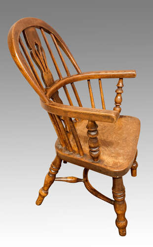 Early 19th century yew and ash child's Windsor armchair.