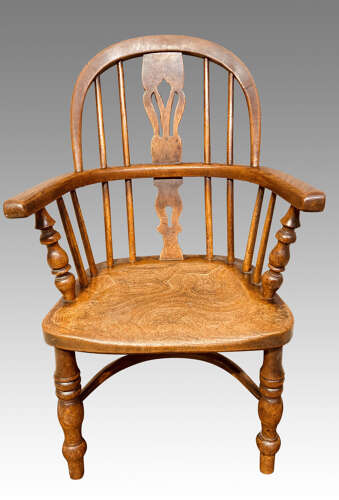 Early 19th century yew and ash child's Windsor armchair.