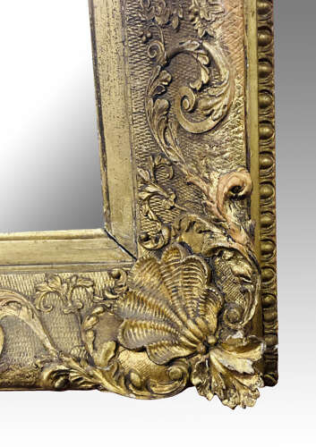 Carved giltwood and gesso wall mirror.