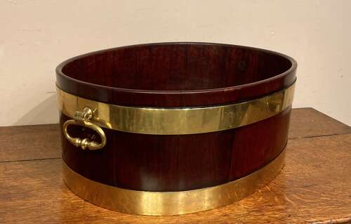 Geo III oval mahogany brass bound planter.