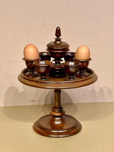 Late Georgian lignum and mahogany revolving egg cruet.
