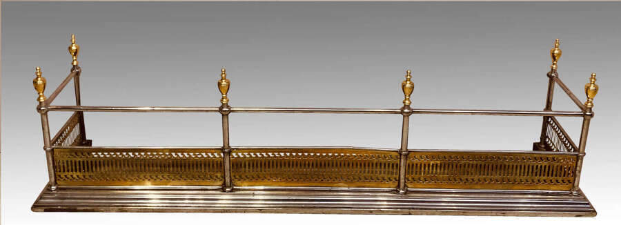 Antique steel and brass fender.
