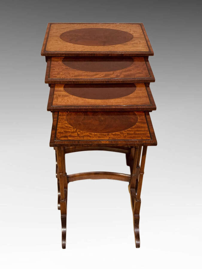 Nest of four inlaid mahogany tables.