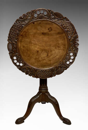 Carved mahogany tilt top tripod table.
