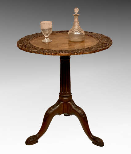 Carved mahogany tilt top tripod table.