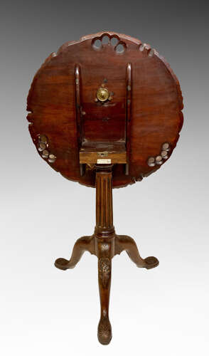 Carved mahogany tilt top tripod table.