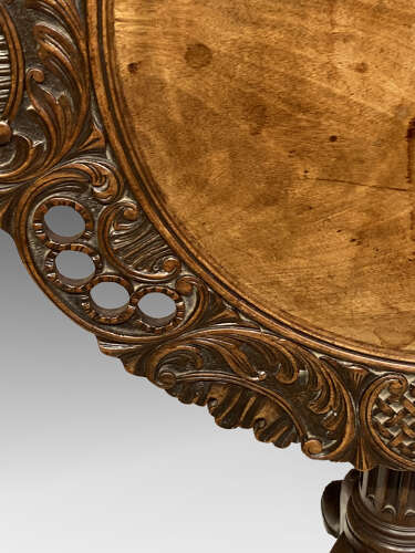 Carved mahogany tilt top tripod table.