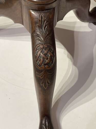 Carved mahogany tilt top tripod table.