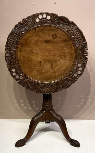 Carved mahogany tilt top tripod table.